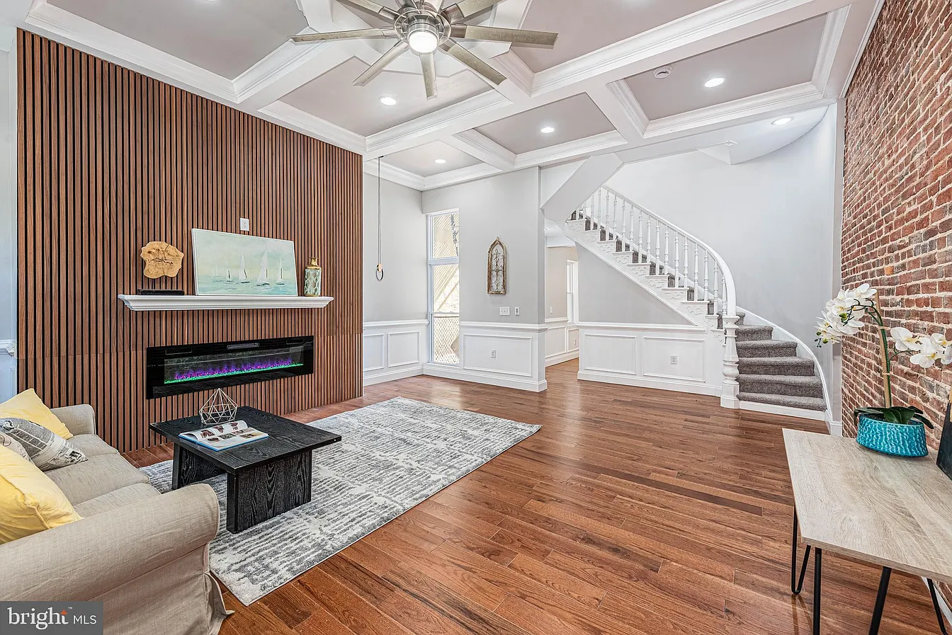 Harlem Park historic rowhome renovation by Maven Homes featuring coffered ceilings and exposed brick