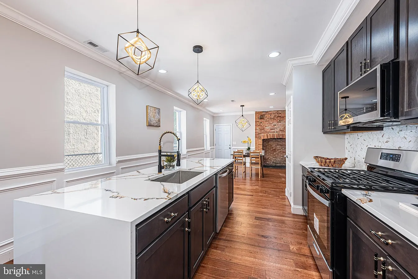 Harlem Park kitchen with quartz waterfall island and geometric pendant lighting