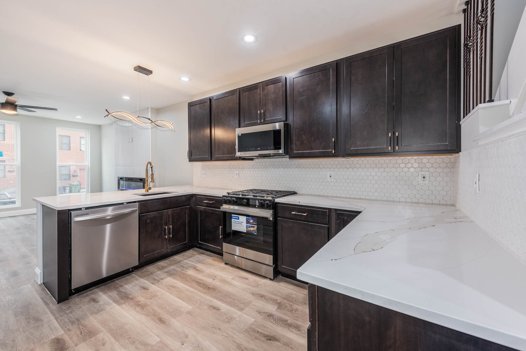 Hollins Market Modern kitchen with hexagonal backsplash and geometric chandelier